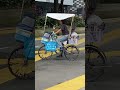 this guy had been creative to put the roof on his bicycle for sunshine