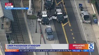 Police standoff underway with Uber passenger armed with a gun