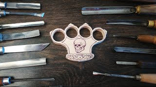 wood carving. brass knuckles carving from linden wood.