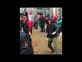 buddy stomping orange in background with his adidas sneakers in public