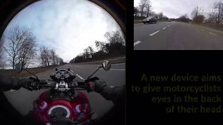 Helmet display shows riders the road behind