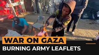Displaced Palestinians burn Israeli army leaflets in Rafah | Al Jazeera Newsfeed