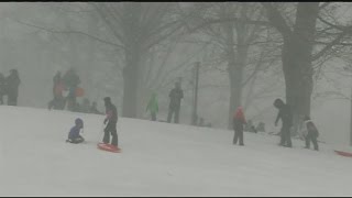 Boston residents venture outdoors for the first snow storm of the season