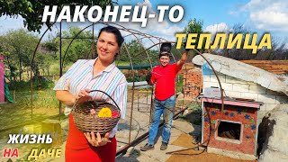 Married couple building a greenhouse. Garden decor from trash. Life in the villageash