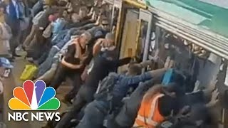 Crowd Lifts 43 Ton Train To Save Man | NBC News