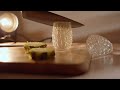 Ultra realistic macro shot of a transparent crystal glass pineapple on a natural warm toned wooden c