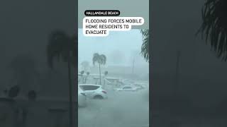 Mobile home residents evacuate as flooding rises Wednesday afternoon in Hallandale Beach.