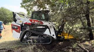 Demo video of a Bobcat T76 Compact Track Loader with a Dominator Tree Puller attachment.