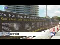 New sign honors 98 lives lost at Surfside building collapse site