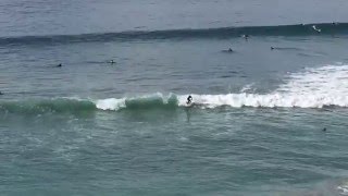 Surfer catching a good ride in Encinitas at Moonlight Beach