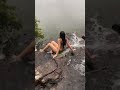 on the edge of a waterfall in the summer rain shorts nature