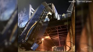 NYC bus dangles precariously from overpass after crash