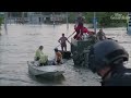 shelling heard overhead as rescuers deploy boats to thousands at risk of floods in kherson