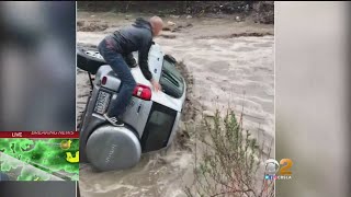 Dramatic Rescue From Overturned SUV In Flood Captured On Video