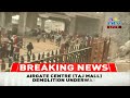 police use tear gas to disperse on lookers at the ongoing taj mall demolition