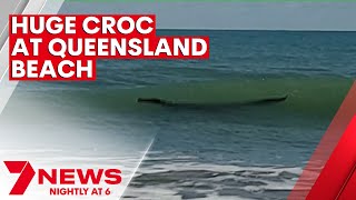 Crocodile spotted swimming at Central Queensland beach | 7NEWS