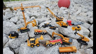 Looking for construction toys behind the rock, crane, roller, breaker, excavator, backhoe, forklift