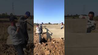 Workers installing cement fence