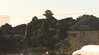 Firefighters continue to put out hot spots at massive junkyard fire in North Philadelphia