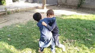 Desi funny wrestling between two little boys at home.بچوں کی کشتی