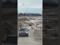 Like a movie: Cars speed up to escape tidal bore waves.