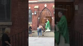 A Catholic Priest waiting on his Parishioners at the entrance of the church #catholicchurch