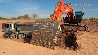 Hitachi Zaxis 350H Excavator Loading Dump Trucks.