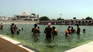 Sikh devotees performing holy bath on Baisakhi at the sarovar in Gurudwara Takht Sri Kesgarh Sahib