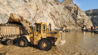 This Wheel Loader Works Like a Monster at Work Site: Caterpillar 966E Loading Rocks into Dump Trucks