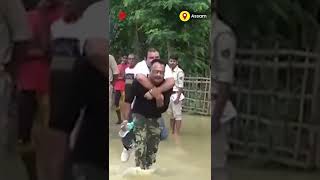 BJP MLA Sibu Misra seen taking a piggyback ride to a boat on the back of a flood rescue worker