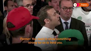 Macron debates with angry farmers | REUTERS