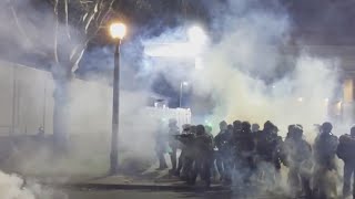 Protesters approach federal officers near ICE building