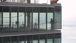 TO High Rise-construction workers installing window on 38th flr Part2