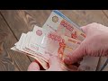 caucasian hand counting small stack of russian ruble banknotes