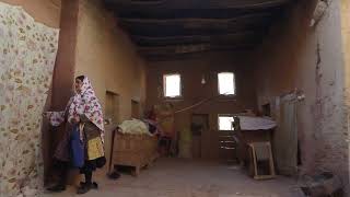 Iranian woman wearing traditional floreal chador in her house, Natanz County, Abyaneh, Iran