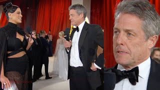 Hugh Grant Stonewalls Ashley Graham On Oscars Red Carpet