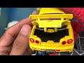 box full of model cars bugatti bolide bugatti chiron koenigsegg jesko range rover vogue gtr r34