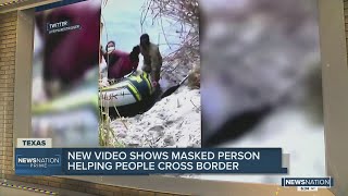 VIDEO: Masked smuggler rafts migrant families across Rio Grande as dozens look on