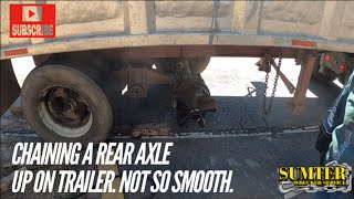 Chaining a rear axle up on trailer. Not so smooth.