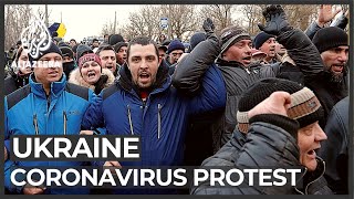 Ukrainian protesters hurl rocks at bus carrying evacuees