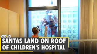 Santas climb down hospital walls in Moscow bringing joy to children | World News | WION News