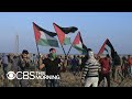 Palestinians march in Gaza to mark one year of protests