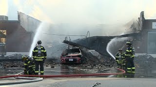 Auto body shop gutted by 4-alarm fire in Mass. town