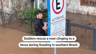 Army rescues man clinging to fence in flood-ravaged Brazil | REUTERS