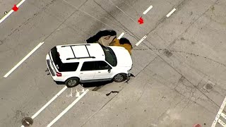 Large sinkhole engulfs SUV along busy Midtown street