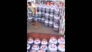 Asian Man Shows Off Loading Skills with Propane Tanks