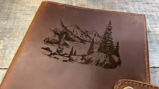 Custom engraved leather journal with a snap closure.