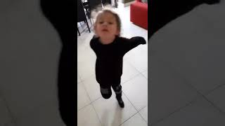 Small kid dancing. Is it a boy or a girl?