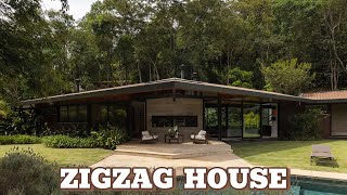 A Tropical House Nestled in the Forest, Where Architecture Blends Seamlessly with Nature.