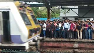 Boarding local train at Malad station, Mumbai.